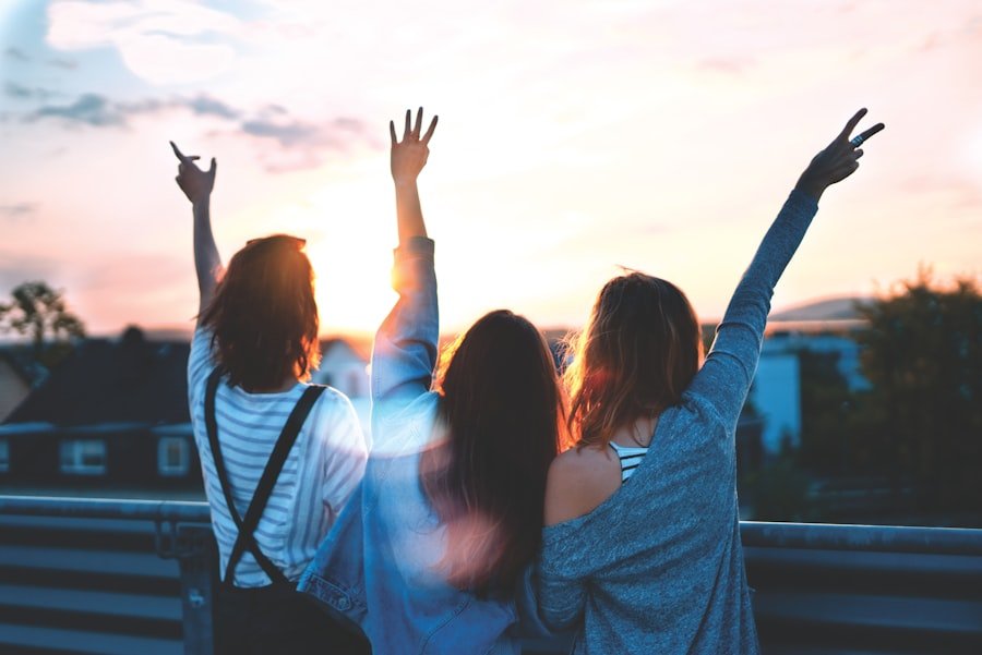 photo of three women lifting their hands